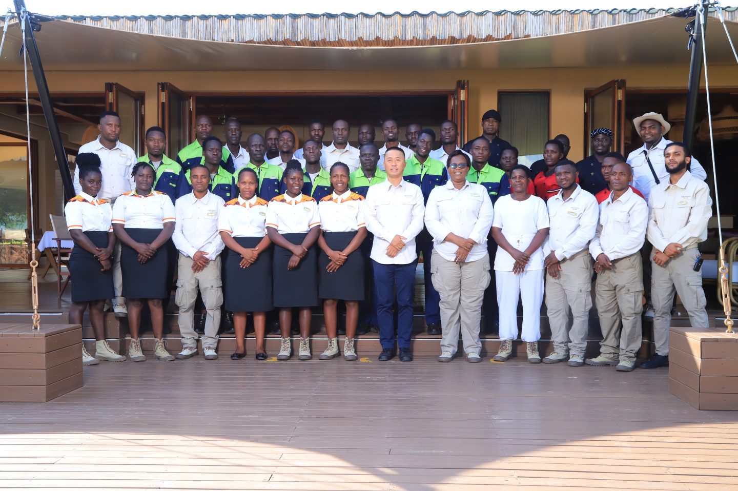 Team members of Entikko Safari Lodge posing together at the lodge grounds
